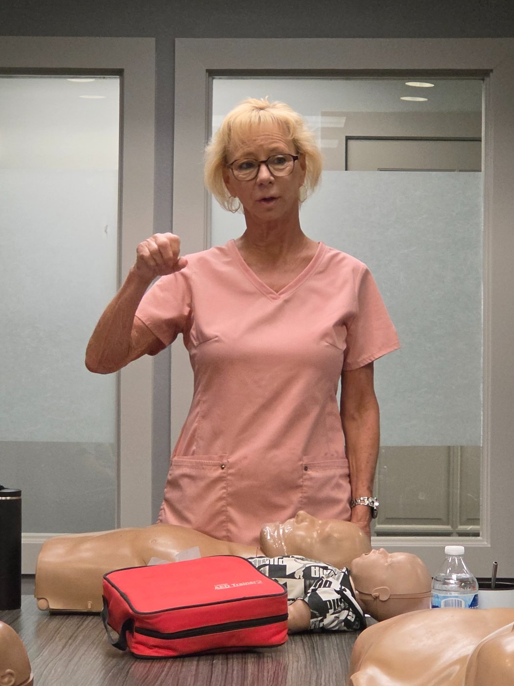 Lynn Prescott demonstrating CPR techniques during a classroom training session