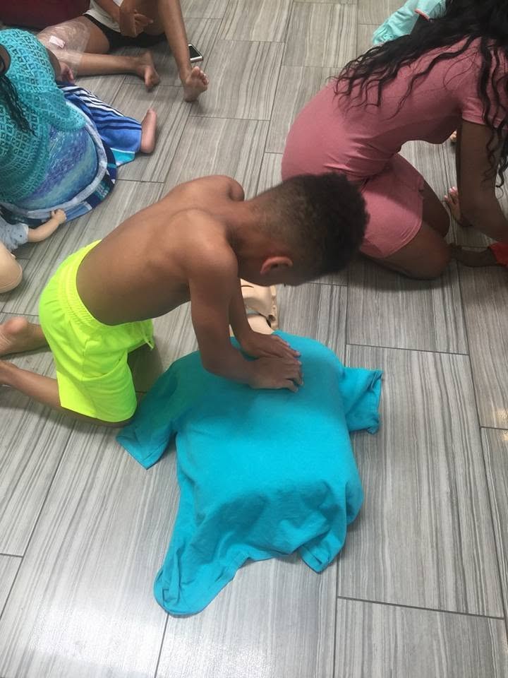 Young participants practicing CPR on training mannequins